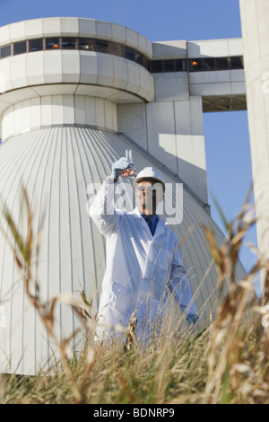 Scientist examining water sample in a flask Stock Photo