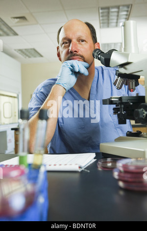 Scientist sitting in a laboratory and thinking Stock Photo