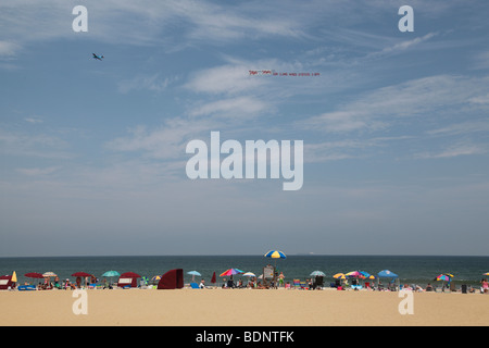 Airplane towing an advertising banner over Virginia Beach, VA. Stock Photo