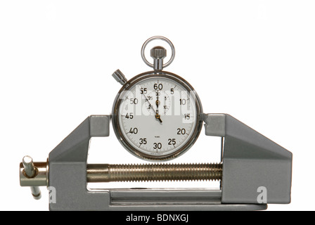 Stopwatch pinched in a vice, symbolic image for time pressure Stock Photo
