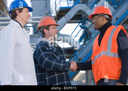 Two engineers shaking hands Stock Photo