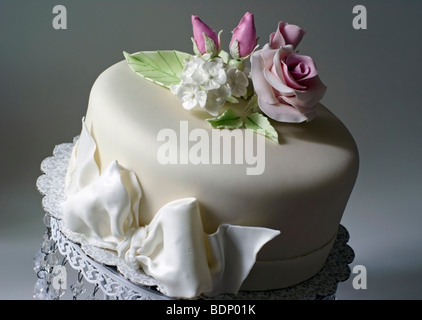 Cake covered with fondant and decorated with pink roses Stock Photo