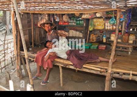 Chin Tribesmen resting in their home and shop in a small village on the Le Mro River near Mrauk U & Chin Villages, Rakhine State Stock Photo