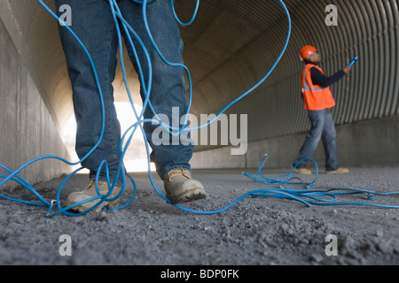 Two engineers working in a tunnel Stock Photo