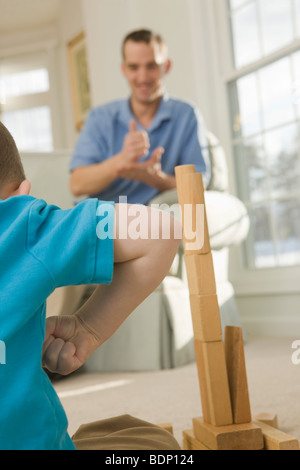 Man signing the word 'Help and boy signing the word 'Strong' in American Sign Language Stock Photo