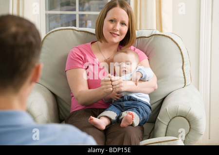 Woman signing the word 'Together' in American Sign Language while communicating with a man Stock Photo