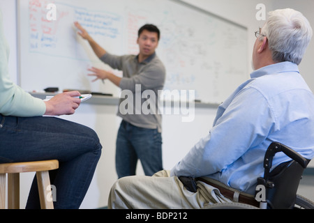 Student explaining to professor in a classroom Stock Photo