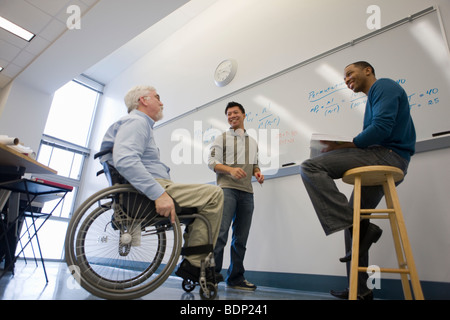 University professor talking with his students in a classroom Stock Photo