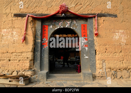 Decorated archway of a round house, Chinese: Tulou, adobe round house of the Hakka minority, Tianluokeng Building Group, Hukeng Stock Photo