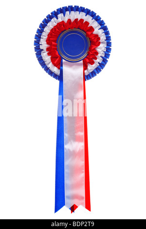 A three tier rosette made with red, white and blue ribbon with a blank disc in the middle, isolated on a white background. Stock Photo