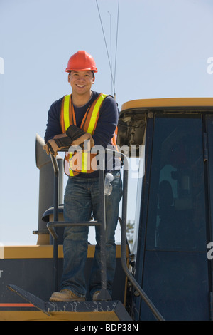 Engineer standing on a bulldozer Stock Photo