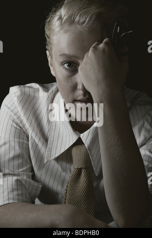 A young woman with blonde hair wearing a business shirt and tie looking at the camera Stock Photo