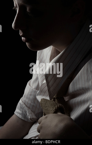 A young woman wearing a striped shirt and tie Stock Photo