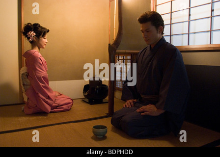 Young couple in kimono having tea ceremony Stock Photo