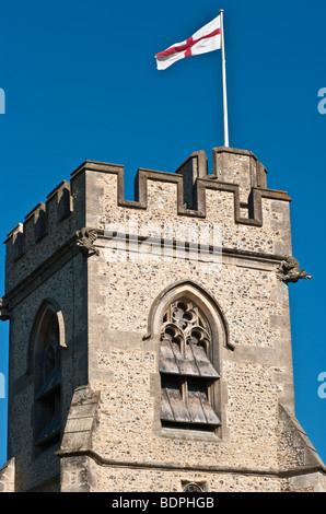 15th/16th century church tower in Chenies village, Buckinghamshire, UK, flying the English flag of Saint George. Stock Photo