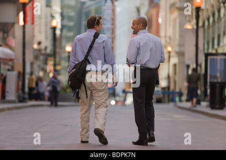 Two men walking together in a street Stock Photo