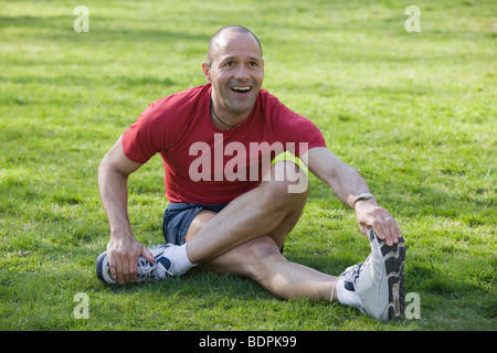Man exercising in a park and smiling Stock Photo