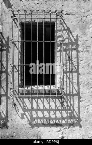 An old window with decorative iron bars Stock Photo