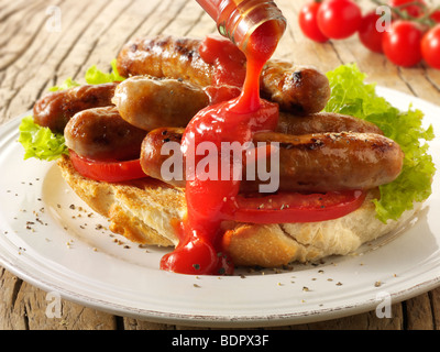 Traditional chipolatta pork sausages with tomato ketchup sandwich Stock Photo
