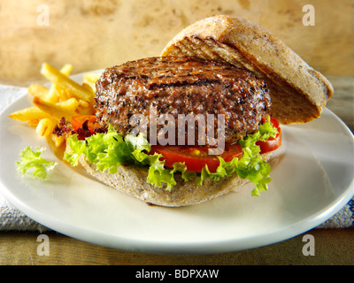 Peppered beef burger with chips and wholemeal bun Stock Photo
