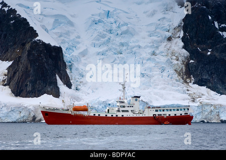 Antarctic Dream exploring icebergs near Pleneau Island Antarctica. Stock Photo