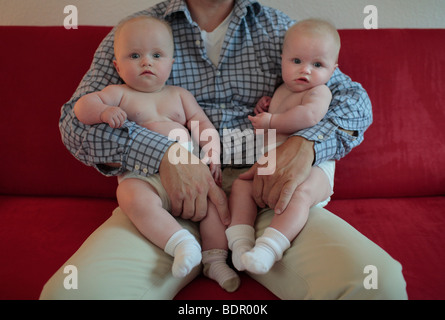 Father with twins, 6 month old. Stock Photo