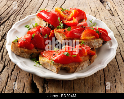 Roast red peppers on toasted rye bread sandwiches - bruschettas. Stock Photo