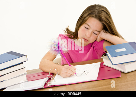Child working on homework on white background Stock Photo