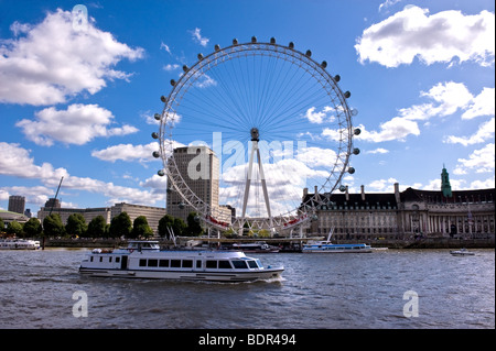 A River Thames pleasure boat sailing past the London Eye. Stock Photo