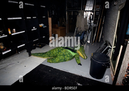 A crocodile costume is pictured laying on the floor backstage at the Theatre Royal, Brighton, East Sussex, UK. Stock Photo