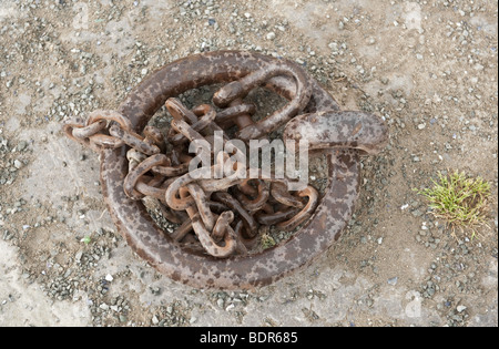 Close up of steel boat mooring ring and link chain with connecting d link on harbour / dock Stock Photo