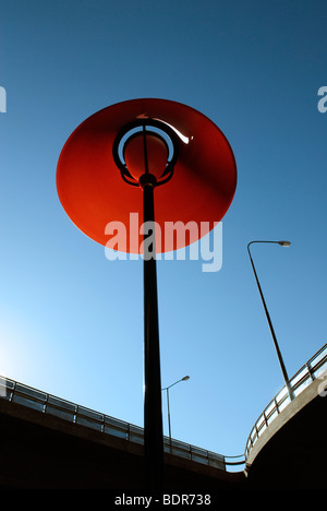 A red outdoor lamp by a viaduct Stockholm Sweden.
