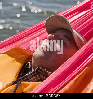 A man lying in a hammock Stock Photo