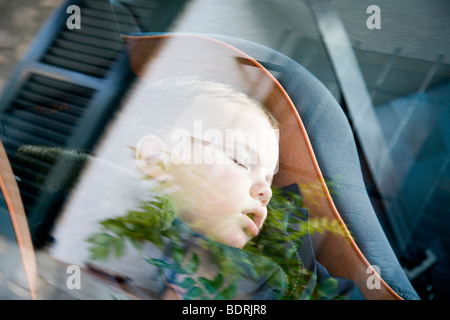 Child sleeping in car seat Stock Photo