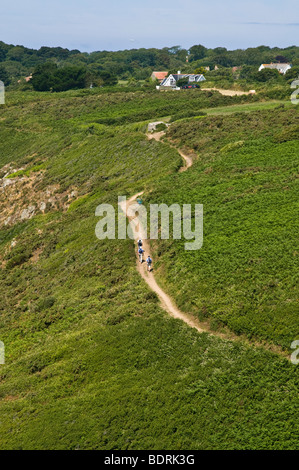 dh Southern coast footpath ST MARTIN GUERNSEY Walkers hiking along hikers walking people walk St Martins path Stock Photo