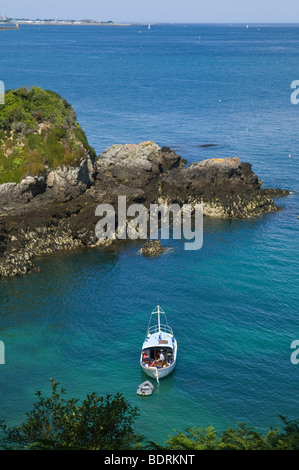 dh Marble Bay ST MARTIN GUERNSEY Couple on yacht at inlet anchor Le Pied du Mur sea boat anchored pleasure coast cove uk sailing sailboat Stock Photo