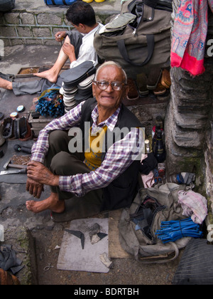 Street cobbler with strong eye glasses. Chamba, Himachal Pradesh. India. Stock Photo