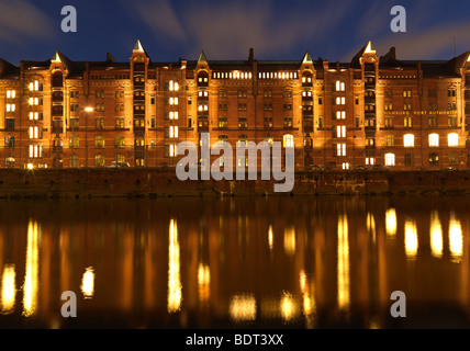 The historic warehouse district of Hamburg, northern Germany, seen under a cloudy sky at the blue hour on February 11, 2009. Stock Photo