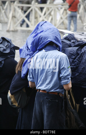 scout group tourists in a queue in heavy rain in vatican, rome Stock Photo