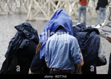 scout group tourists in a queue in heavy rain in vatican, rome Stock Photo