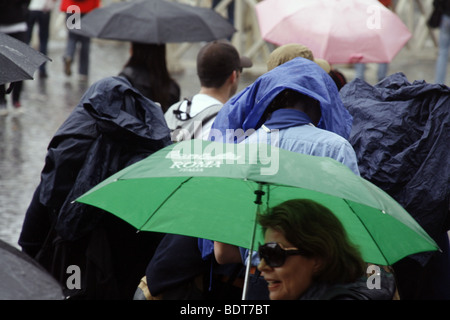 scout group tourists in a queue in heavy rain in vatican, rome Stock Photo