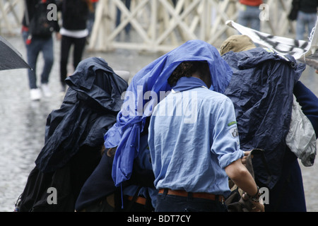 scout group tourists in a queue in heavy rain in vatican, rome Stock Photo