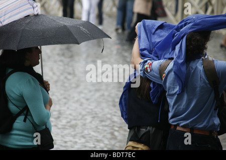 scout group tourists in a queue in heavy rain in vatican, rome Stock Photo