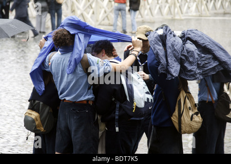 scout group tourists in a queue in heavy rain in vatican, rome Stock Photo