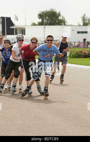 Speed skaters in line racing in a charity race Stock Photo