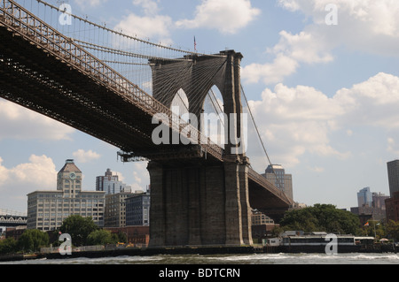 The Brooklyn Bridge. The building to the left of the bridge, now apartments, was erected in 1888. Stock Photo