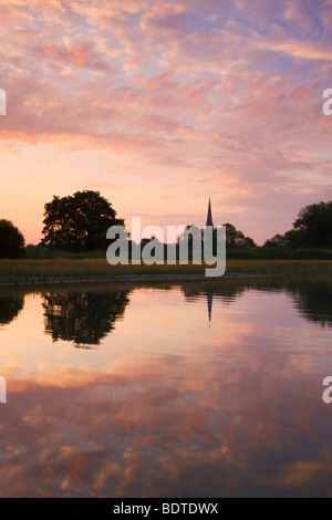 Salisbury Cathedral spire and dawn sky reflected in a pond, Salisbury, Wiltshire, England. Summer (June) 2009. Stock Photo