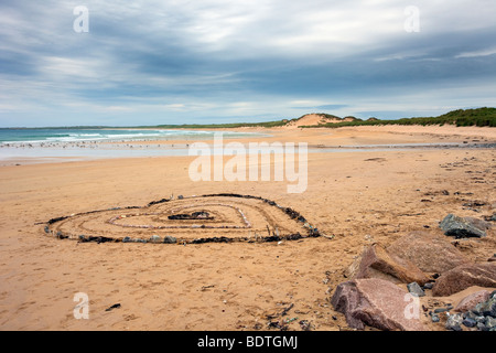 Heartshaped pattern in seaweed & stones; Beach art and sand dunes shoreline landscape at Fraserburgh Bay, Aberdeenshire, Scotland, Great Britain. Stock Photo