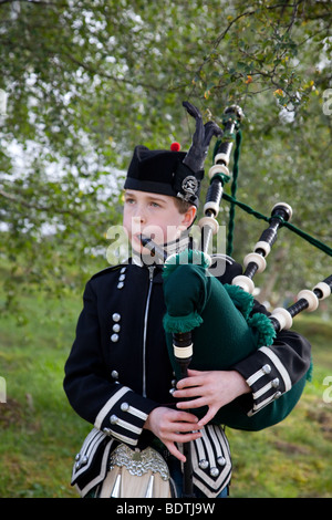 Young boy child piper at the Braemar Royal Highland Gathering Games at the Princess Royal and Duke of Fife Memorial Park, Braemar, Aberdeenshire, uk Stock Photo