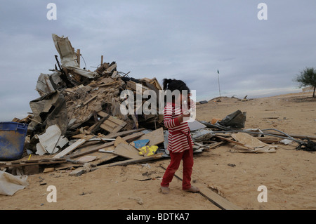 Bedouin girl cries amid ruin of demolished home razed by Israeli authorities in Abdallah Al Atrash unrecognized Bedouin village in Negev desert Israel Stock Photo